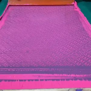 Pink-coated mesh screen secured inside an industrial screen-printing frame