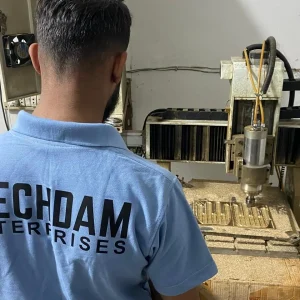 MECHDAM technician operating an in-house CNC machine for TPR impact-glove mould development.